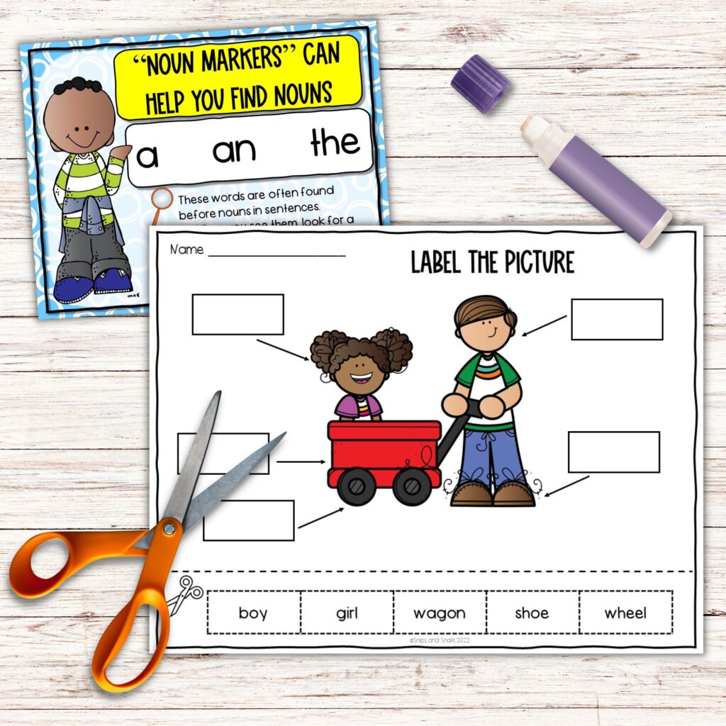 image of cut and paste worksheet, scissors, glue stick, and anchor chart sitting on desktop